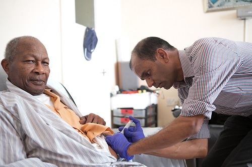 a man recieving an injection in his tummy